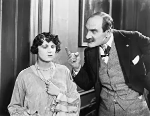 Mustaches: Man scolding a woman