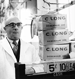Poulterers: Man serving on market stall, London
