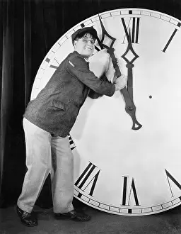 Oversize: Man setting time on a big clock