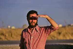 Shading: Man Shading Eyes from Sunlight with Hand Wearing