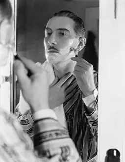 Razors: Man shaving in front of mirror