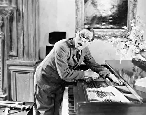 Helpless: Man shouting with his hand caught in a piano