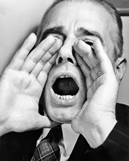 Cupped: Man Shouting with Hands Cupped Around His Mouth Open Wide