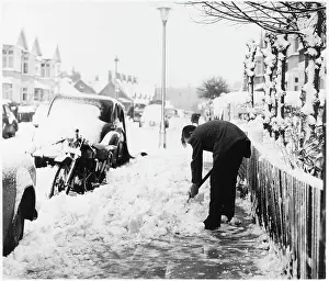 Clearing: MAN SHOVELS SNOW
