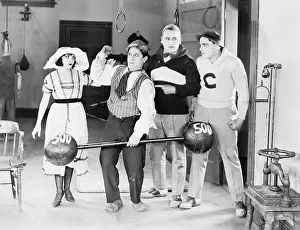 Dumbbell: Man showing off his strength while others watch