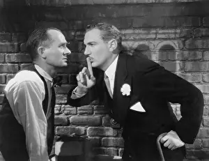 Irritated: One man shushing another
