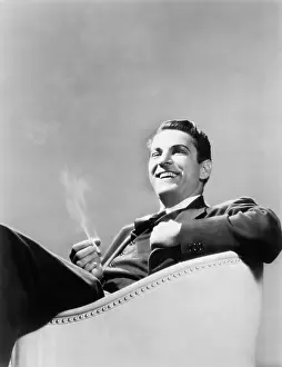 Respecting: Man sitting in an arm chair smoking