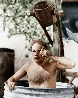 Thirtysomething: Man sitting in a barrel taking a bath and looking