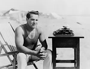 Man sitting at the beach with his typewriter