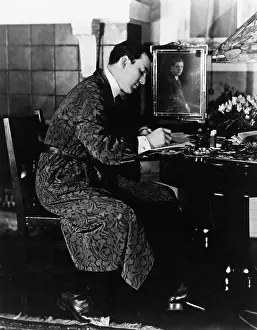 Ponder: Man sitting in a chair and writing