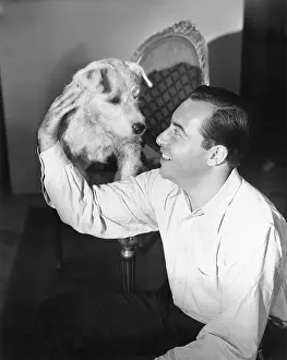 Caress: Man sitting on the floor petting his dog