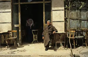 1987egypt: Man sitting outside a coffee house that ?