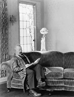 Mustaches: Man sitting on sofa and reading a book