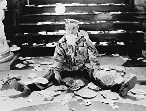 Precarious: Man sitting in front of a staircase with broken