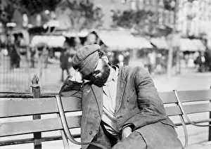 Enclave: Man sleeping with his hat over eyes, on a