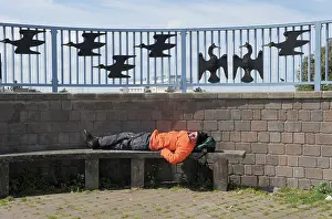 Morecambe: A man sleeps on a bench on Morecambe promenade