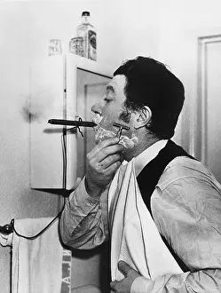 Addicts: Man smoking cigar and shaving