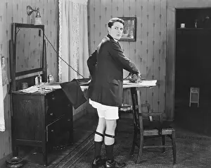 Garters: Man in sock garters ironing