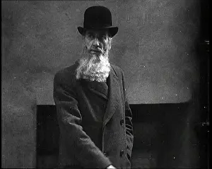 A Man Sporting A Beaver Beard Walking Along A Street