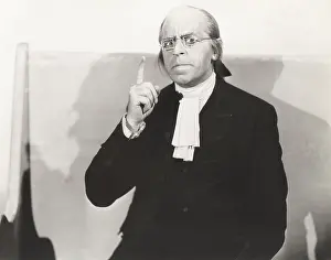 Jabot: Man in square wire rim glasses making a point