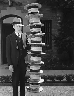 Salesmen: Man with a stack of hats
