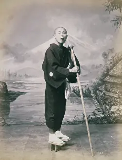 Depict: Man with staff, wearing geta, studio portrait