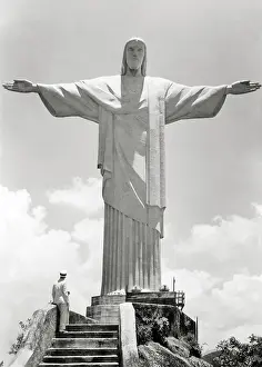 Redeemer: Man Standing at Base of the Sculpture of Christ