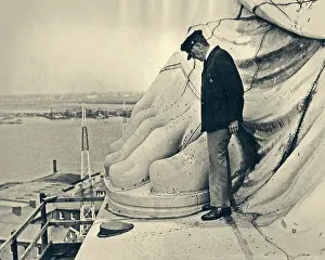 Man Standing by Big Toe of Copper Foot of the