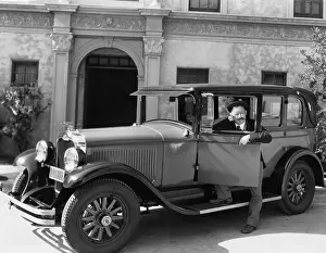 Mustaches: Man standing next to his car