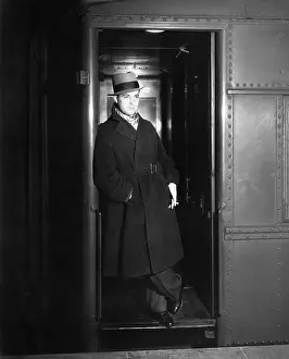 Tilted: Man standing in the doorway of a train waiting