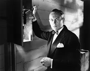 Nightfall: Man standing in front of a fuse box looking frightened