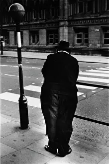 Belisha: Man standing near a zebra crossing in Market Street