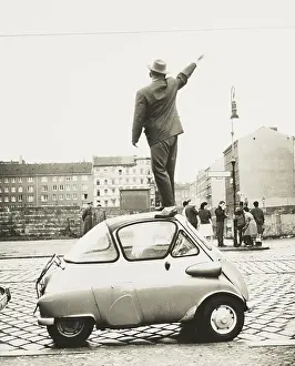 Bernauer: A man standing on top of a small three-wheeled