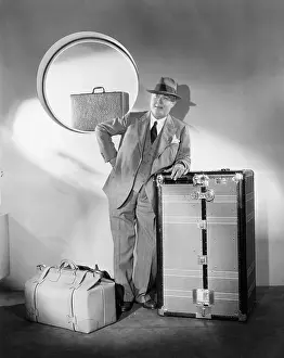 40 45: Man standing and waiting with his luggage