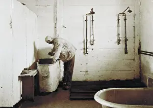 Lavatory: Man standing at a wash tub