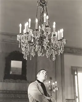 Fragility: Man staring at chandelier