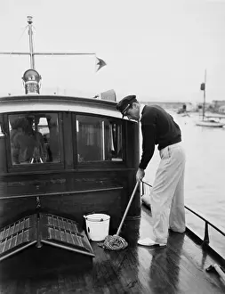 Swabbing: Man swabbing deck of boat