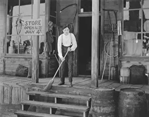 Vocation: Man sweeping steps in front of store