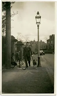 Parked: Man taking an Alsatian dog for a walk