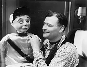 Ventriloquist: Man talking and looking with his puppet