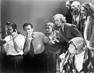 Concentrate: Man talking on the telephone and his friends looking