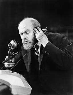 Mustaches: Man talking on the telephone looking intense