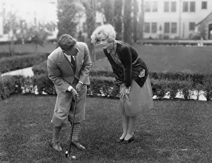 Interactions: Man talking to woman while golfing