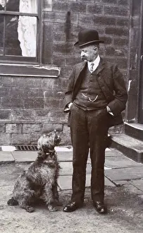 Grate: Man with terrier dog outside a building