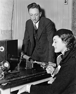 Steadiness: Man testing womans aim with gun