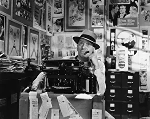 Fedora: Man thinking at typewriter