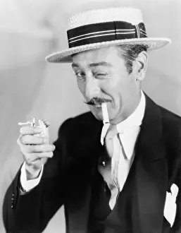 Mustaches: Man trying to light a broken cigarette winking at