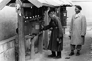 Ulaanbaatar: Man turning prayer wheel, Gandan Monastery, Mongolia