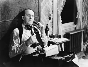 Involve: Man with typewriter talking on phone