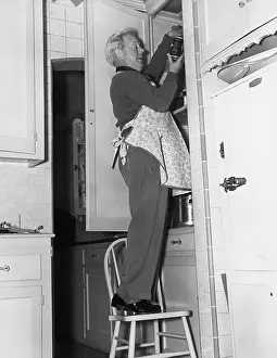 Cupboards: Man wearing apron in kitchen